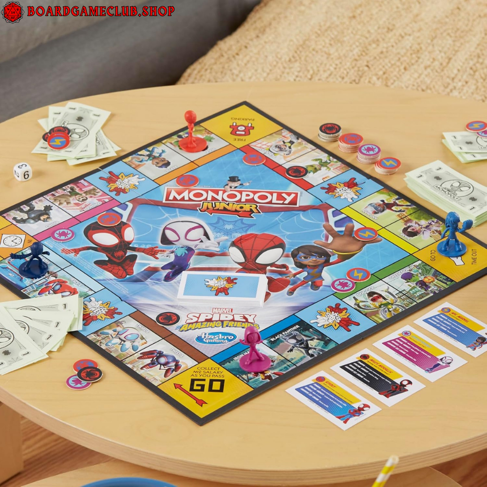 Monopoly Junior Marvel Spidey board game with colorful game pieces and money on a wooden table