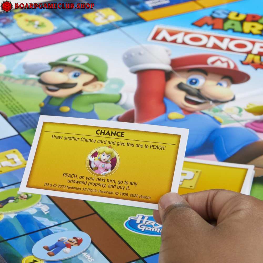 Monopoly Junior Super Mario game board featuring Chance card and colorful character designs