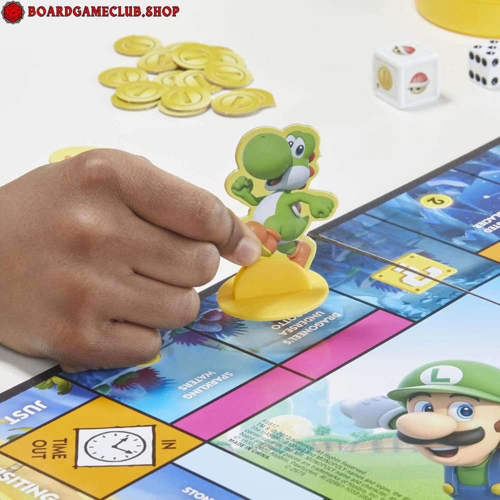 Child playing Monopoly Junior Super Mario with Yoshi piece on the game board