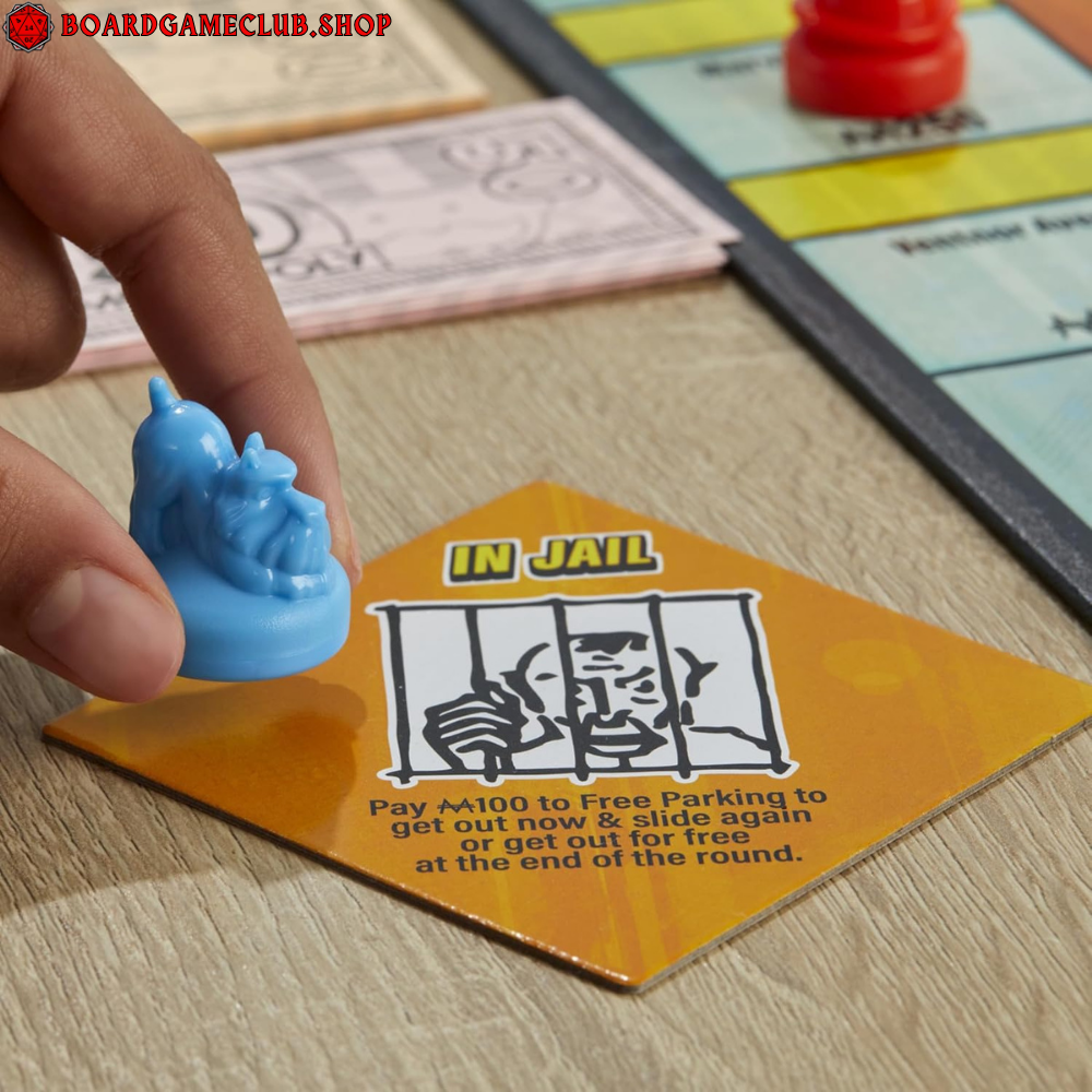 Monopoly Knockout Board Game with player piece and 'In Jail' card on vibrant game board