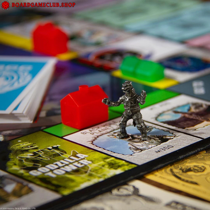 Monopoly Godzilla themed board game with colorful tokens and a detailed Godzilla figure