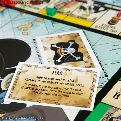 Monopoly One Piece Edition game board featuring a pirate flag card and game pieces for adventure